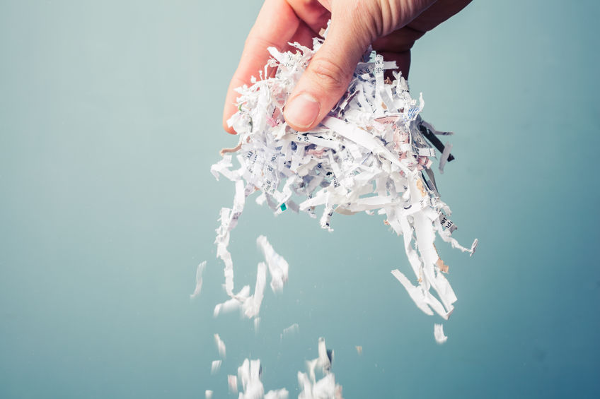 hand holding a bunch of shredded paper